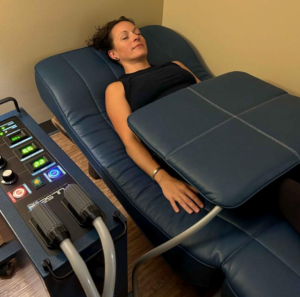 Client receiving PEMF therapy on a commercial wellness recovery device