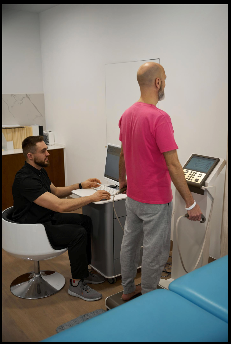 Wellness practitioner using advanced recovery technology during a client session