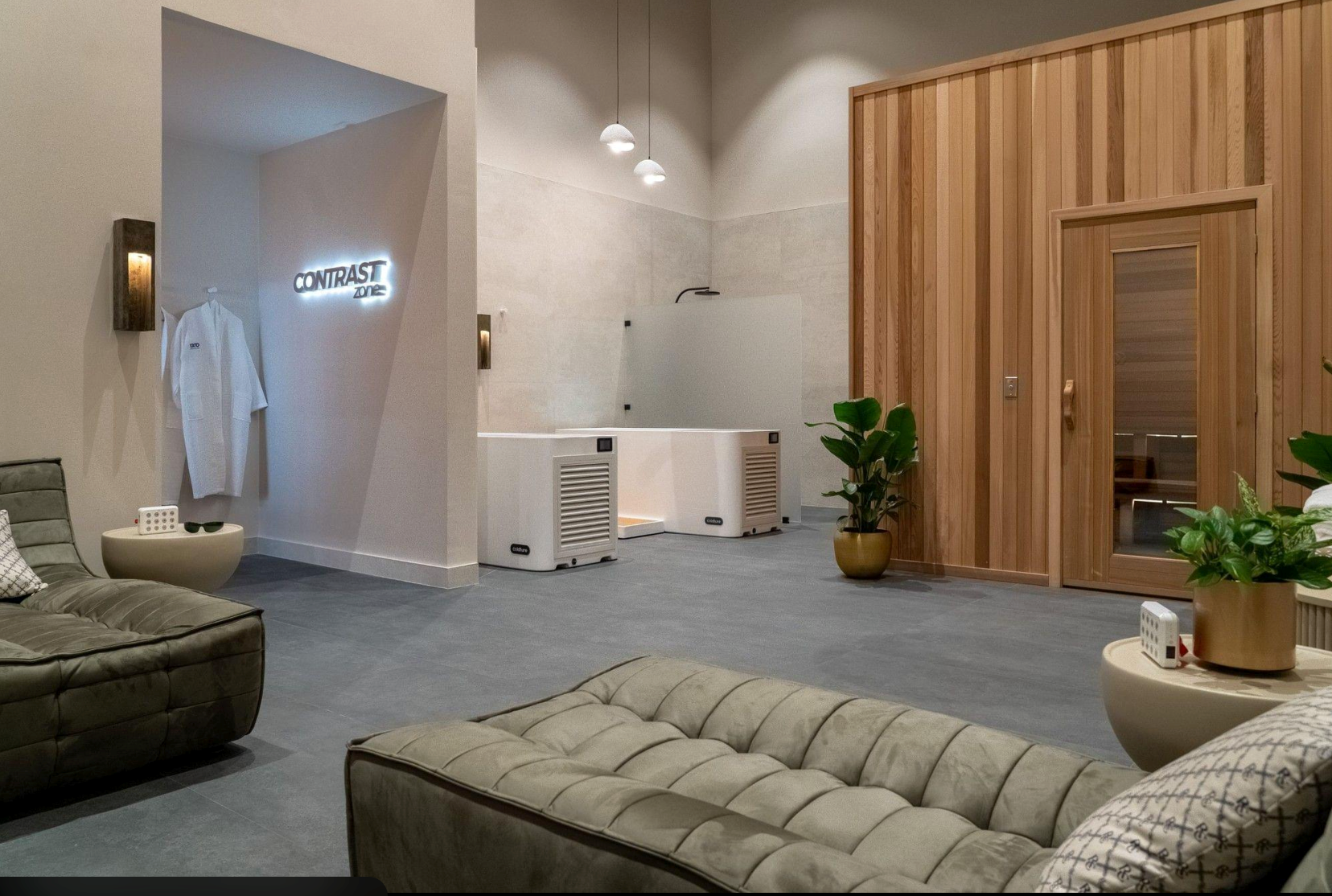 Commercial contrast therapy and recovery facility featuring wellness treatment stations and relaxation chairs.