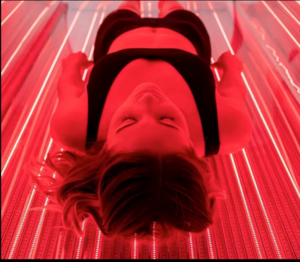 Athlete receiving full-body LED red light therapy for recovery
