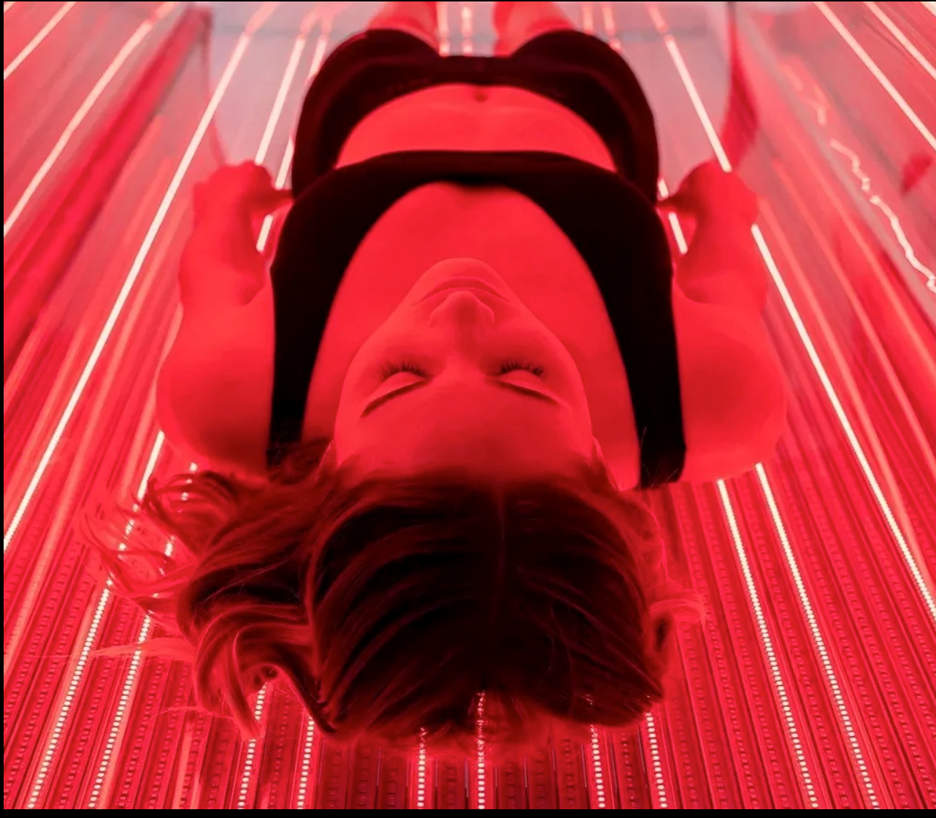 Athlete receiving full-body LED red light therapy for recovery